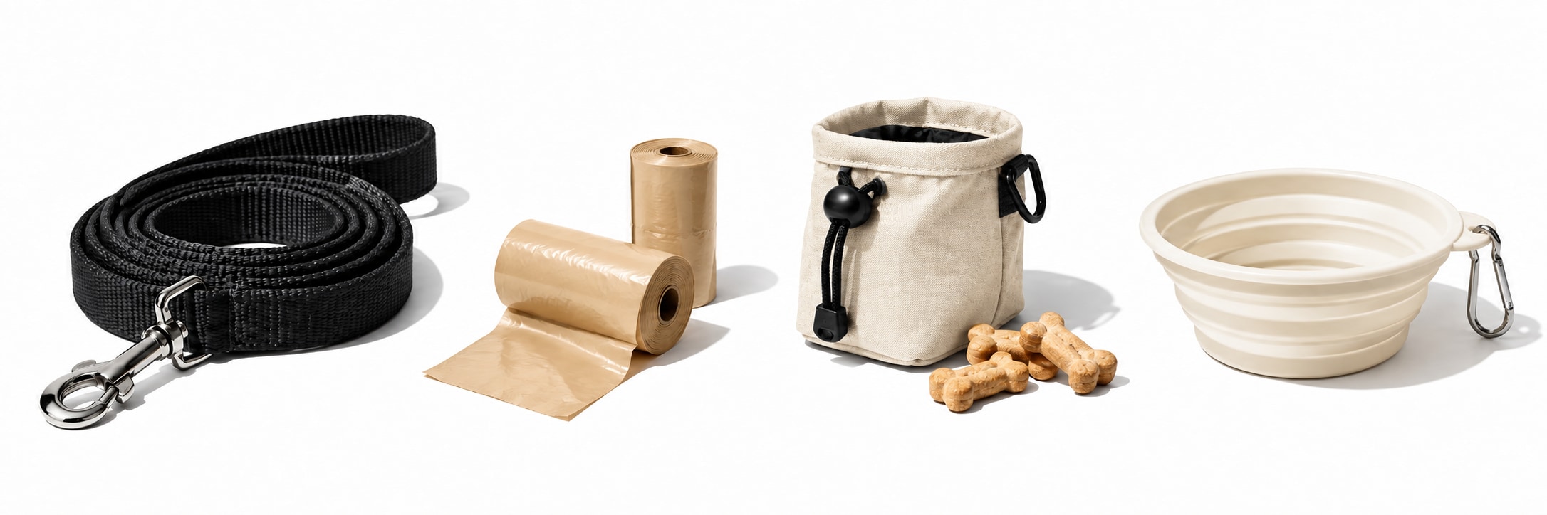 A charcoal leash, beige poop-bag rolls, a canvas treat pouch with dog biscuits, and an ivory collapsible water bowl on a white background